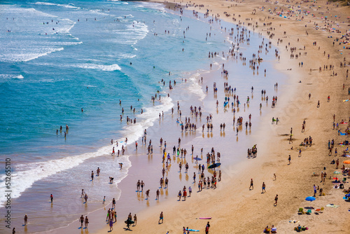 big long shot of people and tourists walking at the beach © Alberto