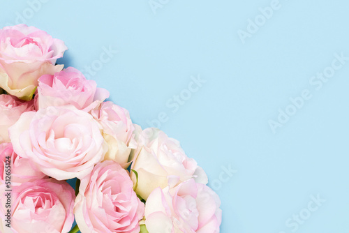 Fototapeta Naklejka Na Ścianę i Meble -  Pink roses on a light blue background. Mother's day, Valentines Day, Birthday celebration concept