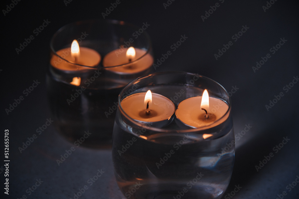 lit candles on water in candlesticks lit candles on water in candlesticks