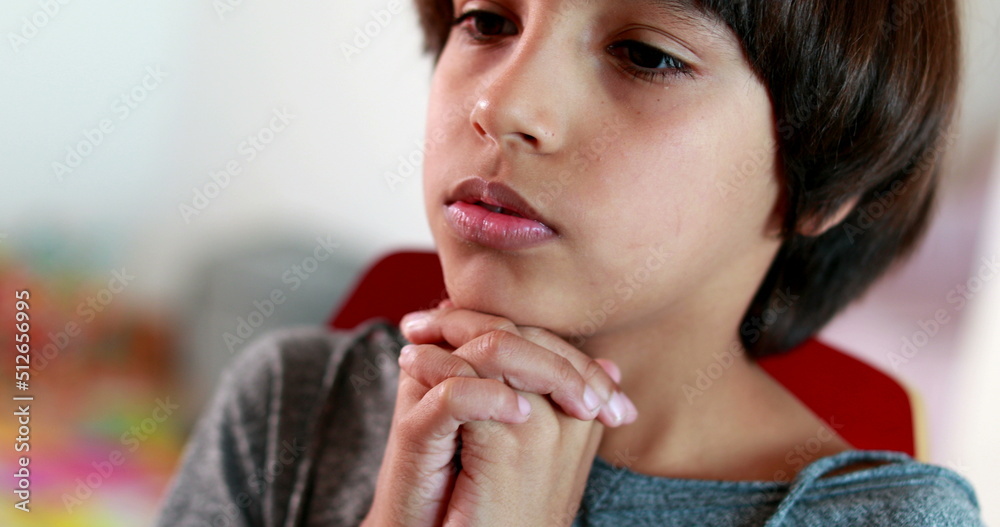Boy praying to God with hands held together. Mixed race child prays spiritually faithful belief Boy praying to God with hands held together. Mixed race child prays spiritually faithful belief