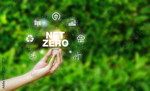 Net zero icon and carbon neutral concept in the hand for net zero greenhouse gas emissions target Climate neutral long term strategy on the natural background.                         