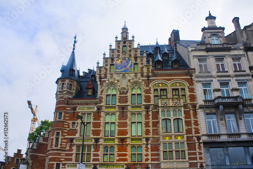 Pharmacie Anglaise in historic mansion with tower, product names in gold, red-white facade, bluish roof and sun dial on Koudenberg in central Brussels, Belgium