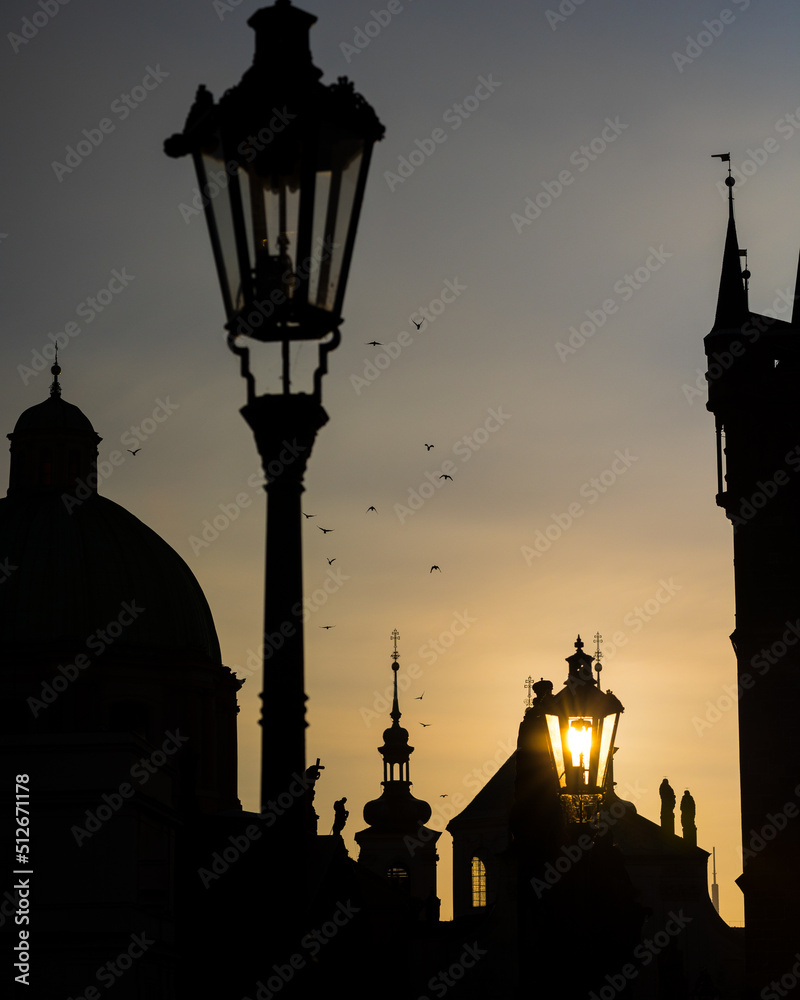 silhouette of a church during sunrise on Charles bridge Prague