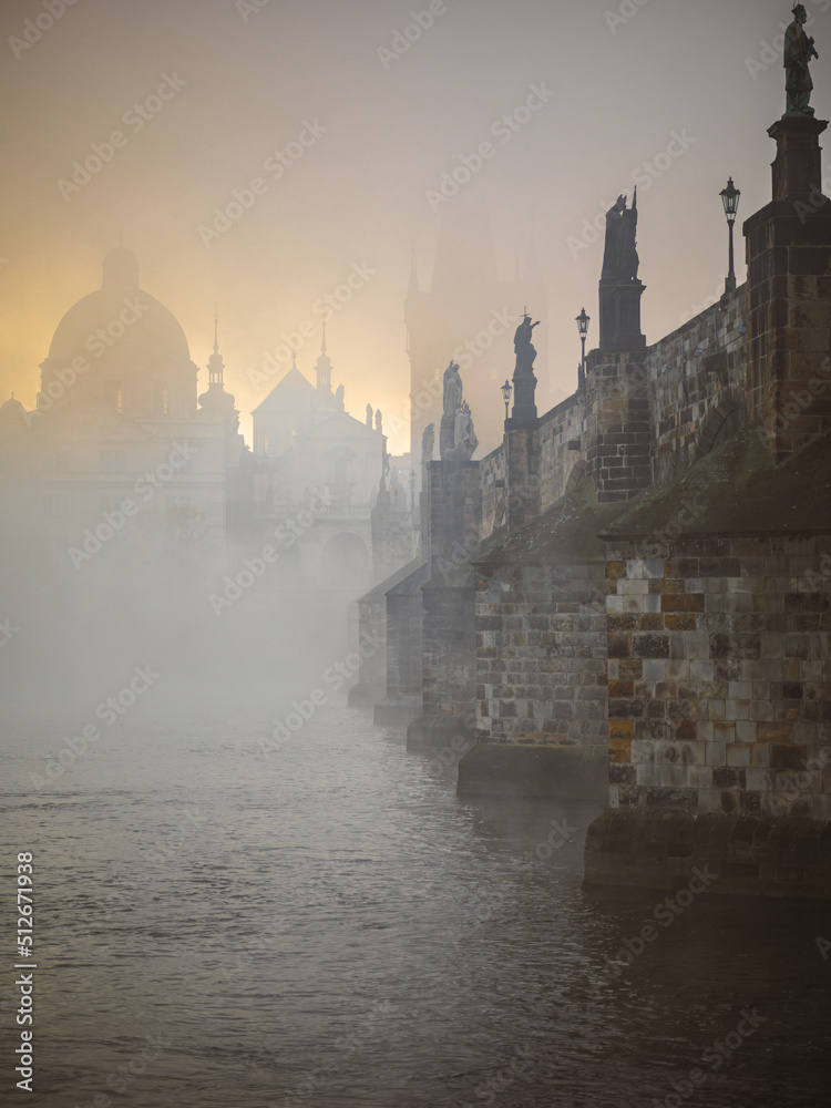 sunrise over the Charles bridge with mist in Prague