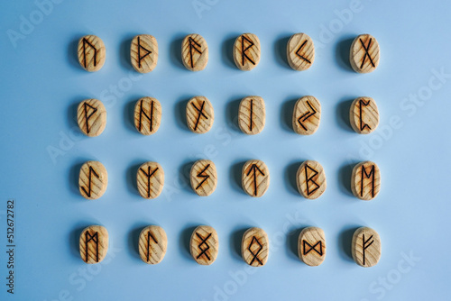 Set of the wooden scandinavic runes in the blue background photo