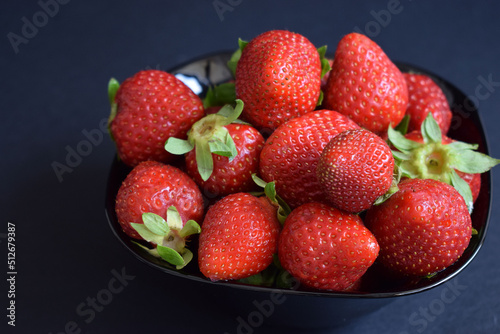 Fototapeta Naklejka Na Ścianę i Meble -  A ration of fresh strawberries on a black background
