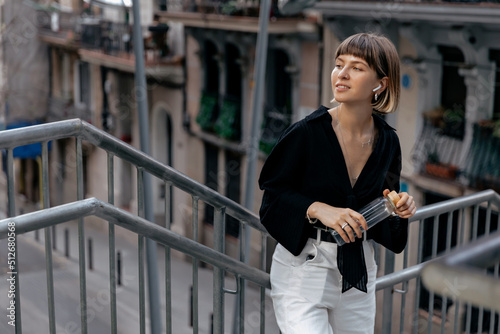Obraz na płótnie Outdoor portrait of stylish european girl with short stylish hair wearing casual clothes looking aside with lovely smile. Pretty woman walking on street with happy emotions w salonie
