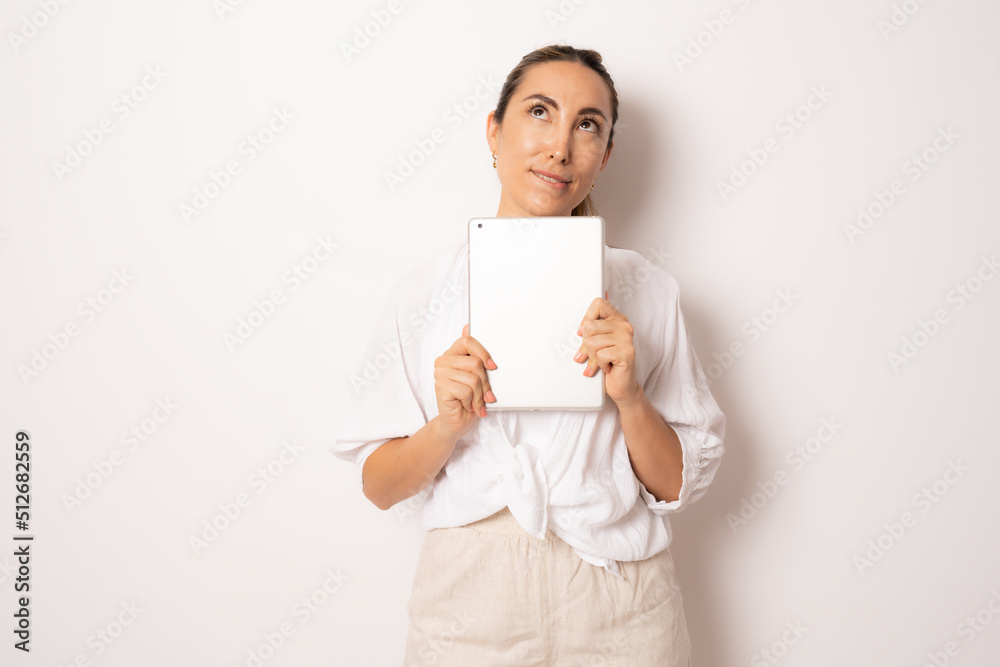Image of young brunette woman, company worker, doubtful and holding digital tablet, standing over white background Image of young brunette woman, company worker, doubtful and holding digital tablet, standing over white background