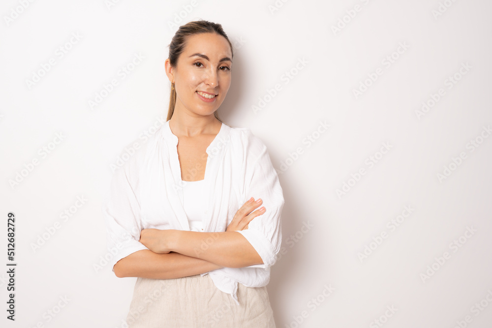 Young business woman in white casual shirt standing with arms folded isolated over white background. Young business woman in white casual shirt standing with arms folded isolated over white background.