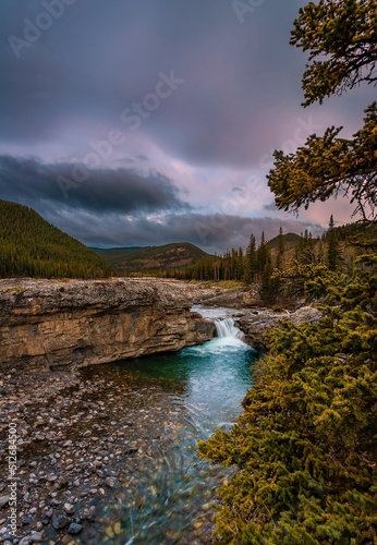 Sunrise Clouds Over Elbow Falls In The Spring