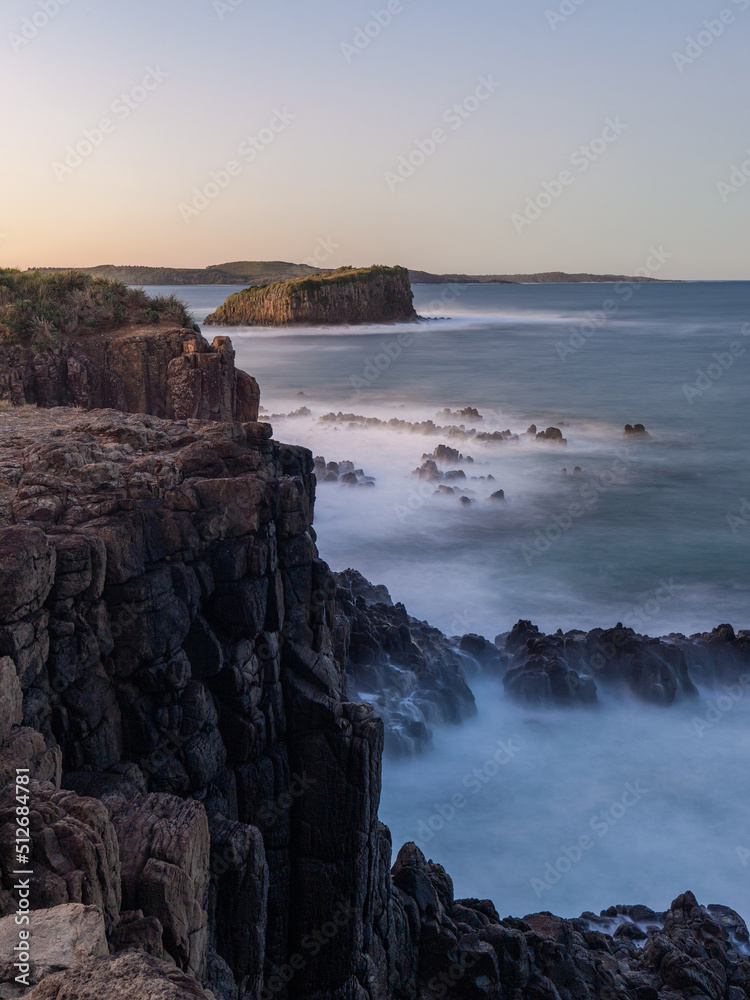 Long exposure view of seascape cliff during sunset time.