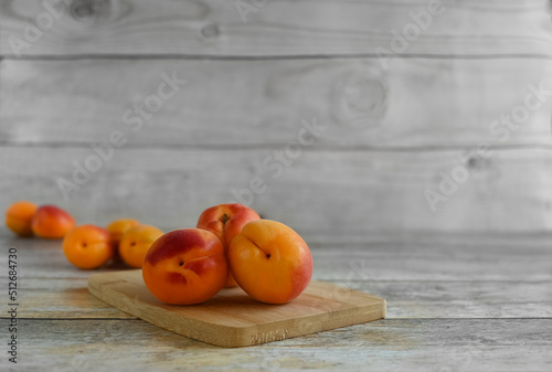 Fresh ripe apricots on a wooden table, copy space . Apricots are rich in vitamins and minerals such as: vitamin A, beta-carotene, vitamin C, potassium, silicon, cobalt, manganese, copper
