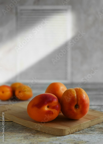 Fresh ripe apricots on a wooden background, copy space. Apricots are rich in vitamins and minerals such as: vitamin A, beta-carotene, vitamin C, potassium, silicon, cobalt, manganese, copper