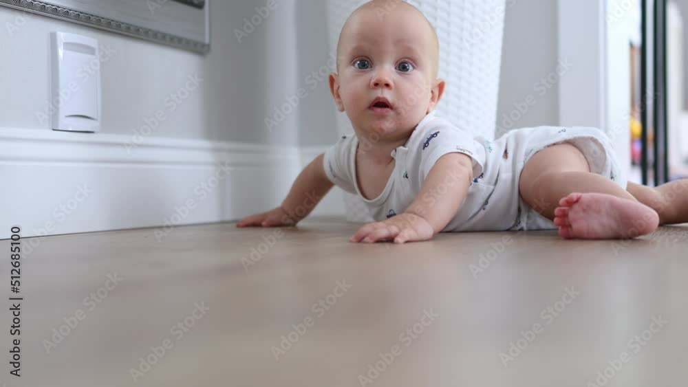 cute baby infant looking camera, smiling, trying crawl. portrait caucasian baby lying on wooden floor in living room, learning crawling. stomach time. 6-7 months baby moving body hands legs, airplane cute baby infant looking camera, smiling, trying crawl. portrait caucasian baby lying on wooden floor in living room, learning crawling. stomach time. 6-7 months baby moving body hands legs, airplane