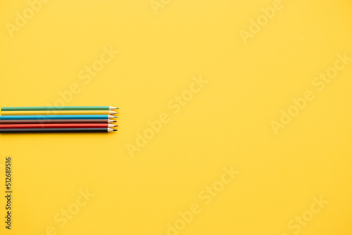closeup color pencil on yellow background, back to school concept