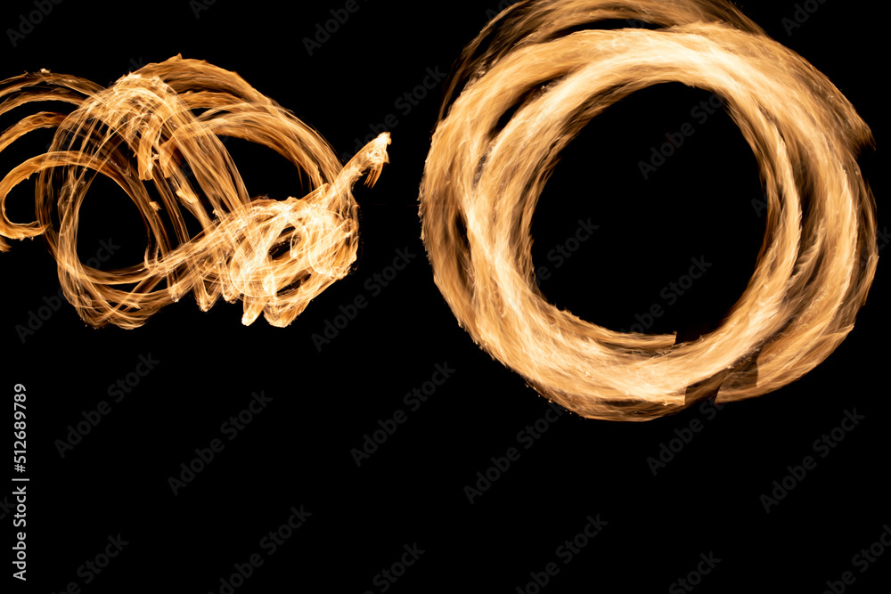 Circles of flames in dark. Fire show on long camera shutter speed. Flames. Circles of flames in dark. Fire show on long camera shutter speed. Flames.