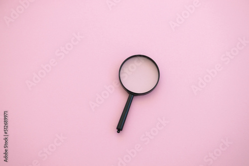 magnifying glass on pink background. Search concept