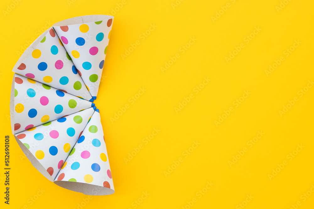 Birthday party hats on yellow background