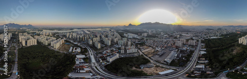 Aerial view of Jacarépagua lagoon in Rio de Janeiro, Brazil. Residential buildings and mountains around the lake. Barra da Tijuca beach in the background. Sunny day. Sunset. Drone photo photo