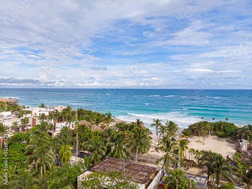 View of coastal area with wavy blue Caribbean Sea on a cloudy day in Tulum beach
