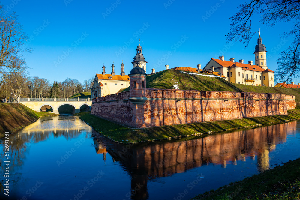 Scenic winter landscape with architectural and cultural complex of Nesvizh Castle on sunny day, Minsk region, Belarus