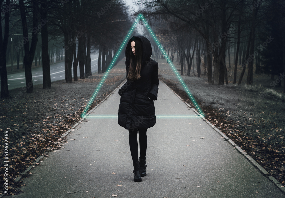 Girl on the scary road in the paranormal world. Strange forest in a fog. Mystical atmosphere. Dark wood. Mysterious road. Gothic witch. Background wallpaper. Gloomy times. Dark background Girl on the scary road in the paranormal world. Strange forest in a fog. Mystical atmosphere. Dark wood. Mysterious road. Gothic witch. Background wallpaper. Gloomy times. Dark background