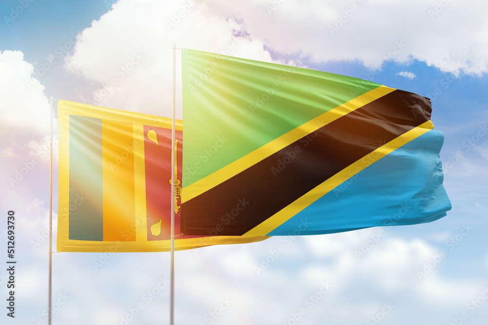 Sunny blue sky and flags of tanzania and sri lanka