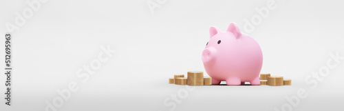 Pink piggy bank with several coins on a white background - savings concept photo