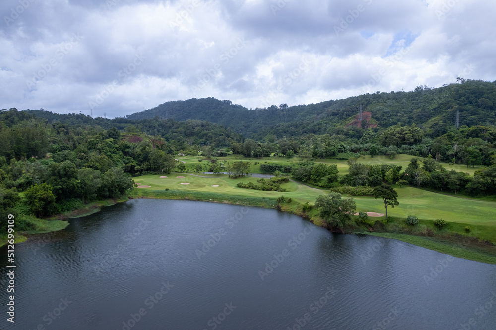 Aerial view drone shot of beautiful green golf field fairway and putting green Top down image for sport background and travel nature background Amazing view