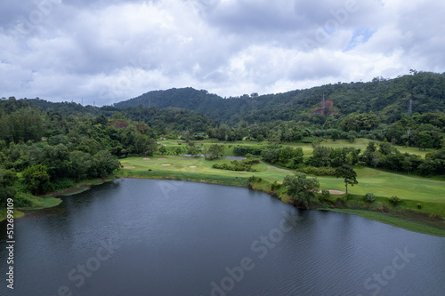 Aerial view drone shot of beautiful green golf field fairway and putting green Top down image for sport background and travel nature background Amazing view