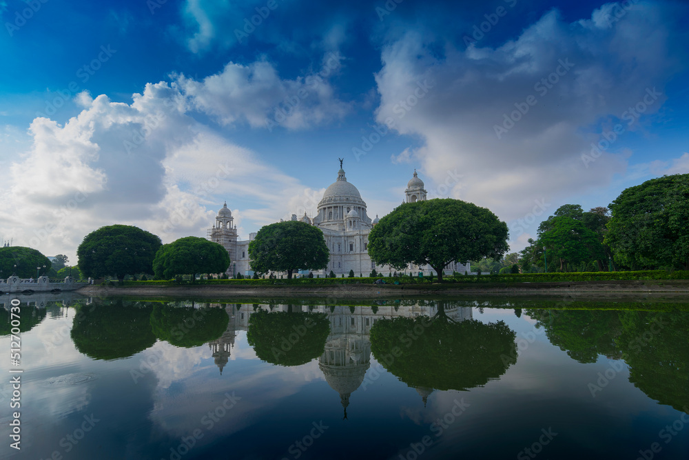 Victoria Memorial, Kolkata , Calcutta, West Bengal, India with blue sky and reflection on water. A Historical Monument of Indian architecture, to commemorate Queen Victoria's 25 years reign in India.