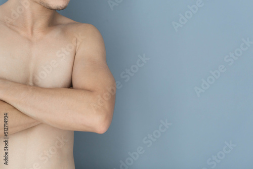 Closeup asian man crossed hand with blue background, health care concept