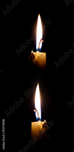 Candle flames on black background.