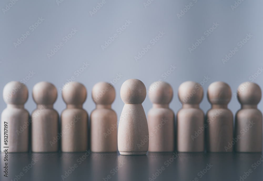 Several wooden blocks of people are lined up on the table. Several wooden blocks of people are lined up on the table.