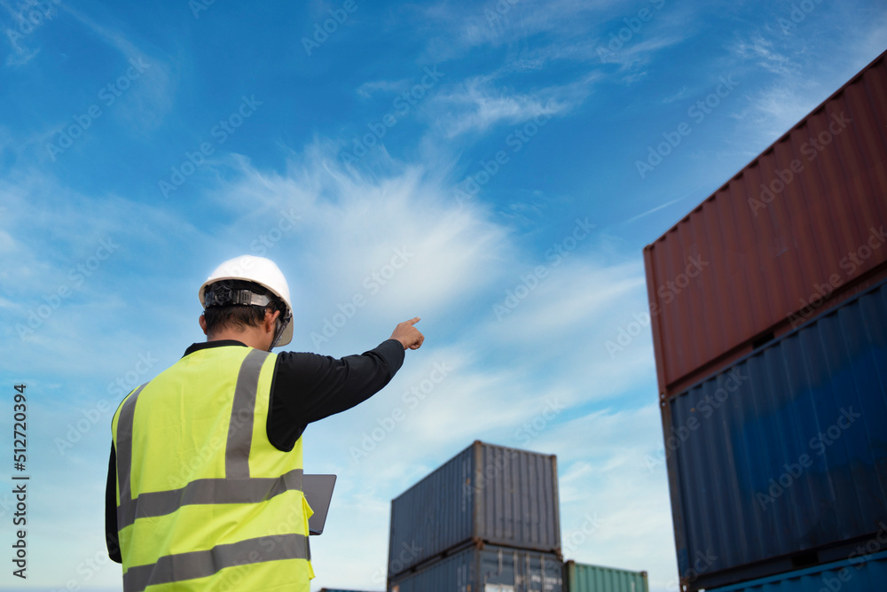 Foreman controls the loading of containers from cargo ships for import and export,Foreman or Supervisor in Container Terminal. Foreman controls the loading of containers from cargo ships for import and export,Foreman or Supervisor in Container Terminal.