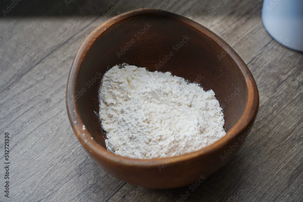 A handful of flour is in a plate on the table. A handful of flour is in a plate on the table.