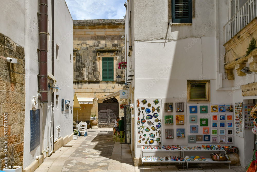 A narrow street among the old houses in the historic center of Otranto, a town in Puglia in Italy.