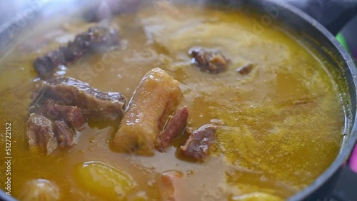 Close up of wooden ladle stirring traditional Dominican creole food called Sancocho photo
