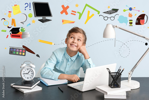 Cute little boy doing homew...