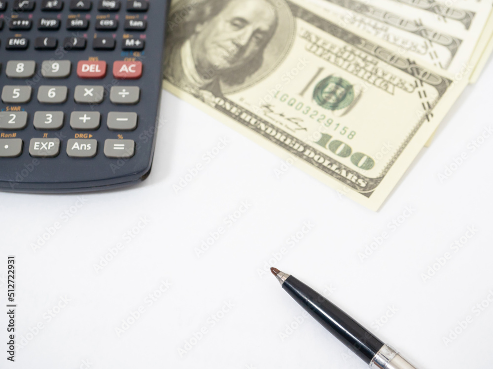 Close up pen with calculator and money isolated white Close up pen with calculator and money isolated white