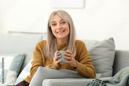 Beautiful senior woman drin...