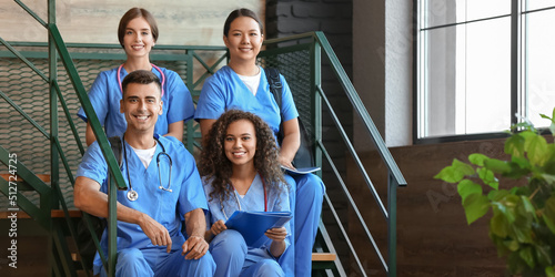Group of students sitting on stairs in modern clinic