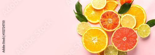 Different cut citrus fruits on pink background with space for text  top view