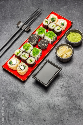 Set of sushi on red plate.