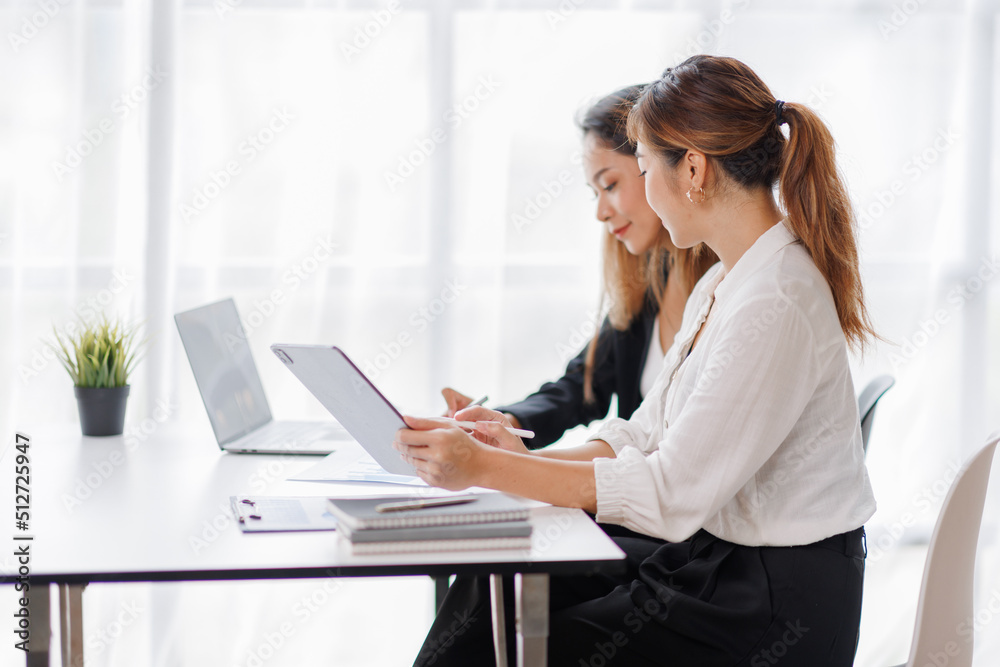 Cropped shot of Asian Business woman diverse coworkers working together in the boardroom, brainstorming, discussing, and analyzing business report strategy collaboration. Cropped shot of Asian Business woman diverse coworkers working together in the boardroom, brainstorming, discussing, and analyzing business report strategy collaboration.