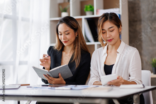 Cropped shot of Asian Business woman diverse coworkers working together in the boardroom, brainstorming, discussing, and analyzing business report strategy collaboration.