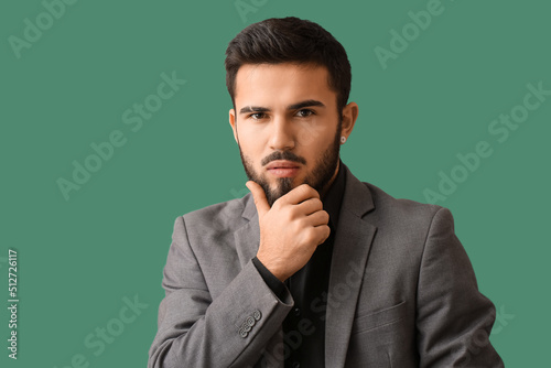 Pensive bearded man on gree...