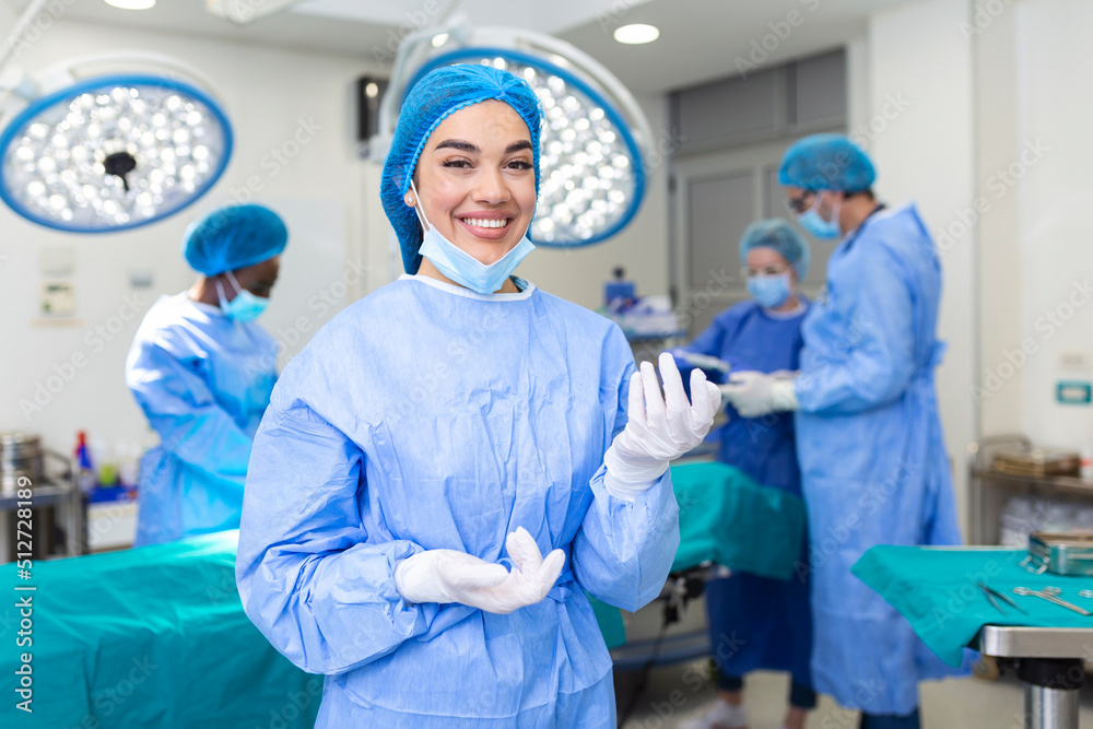 Portrait of female woman nurse surgeon OR staff member dressed in surgical scrubs gown mask and hair net in hospital operating room theater Portrait of female woman nurse surgeon OR staff member dressed in surgical scrubs gown mask and hair net in hospital operating room theater
