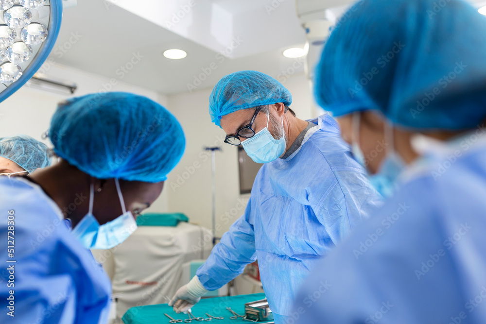 Surgeon team in uniform performs an operation on a patient at a cardiac surgery clinic. Modern medicine, a professional team of surgeons, health. Surgeon team in uniform performs an operation on a patient at a cardiac surgery clinic. Modern medicine, a professional team of surgeons, health.