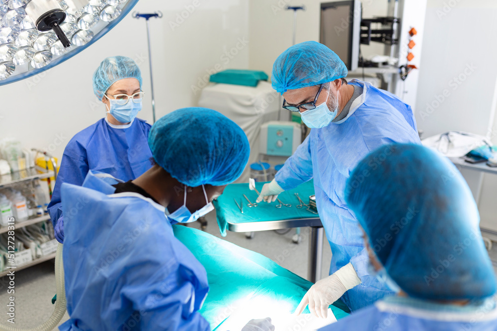 Surgeon team in uniform performs an operation on a patient at a cardiac surgery clinic. Modern medicine, a professional team of surgeons, health. Surgeon team in uniform performs an operation on a patient at a cardiac surgery clinic. Modern medicine, a professional team of surgeons, health.